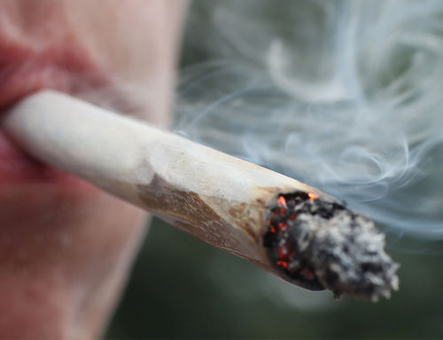 A marijuana is smoked like a typical cigarette to intensify its effect image photo picture
