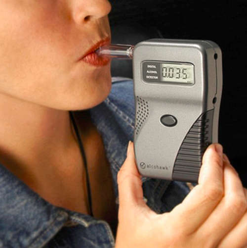 A small device is used to detect the alcohol content in the breath. It also detects the alcohol intoxication level image photo picture